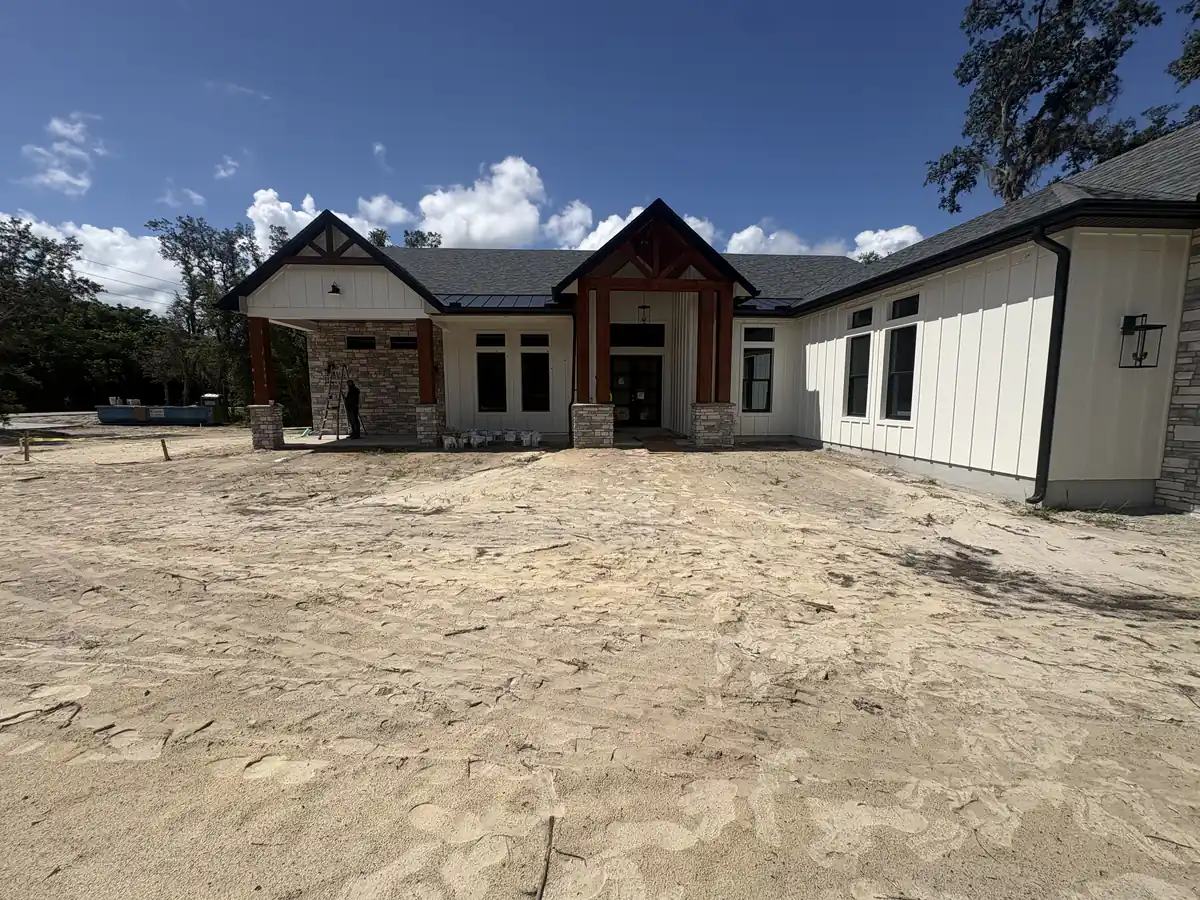Lake Mary new construction ranch home with a bare sand front yard before landscaping