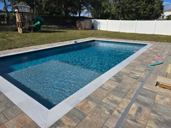 Close up of pool sun shelf and multi-toned pavers