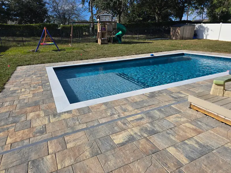 Large custom paver pool deck and hardscape landscaping in DeLand